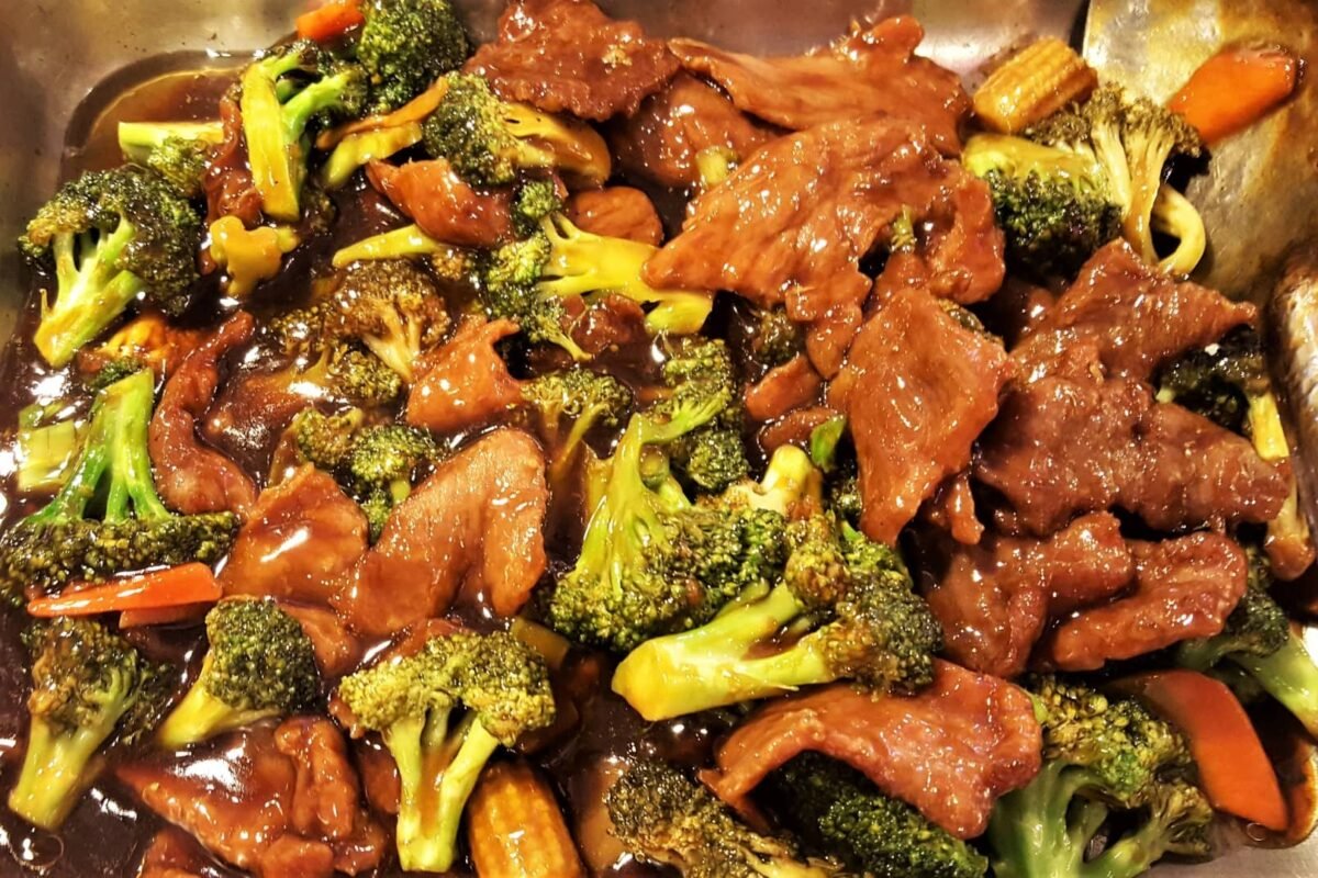 Beef and broccoli in a rich oyster sauce served in a pan.