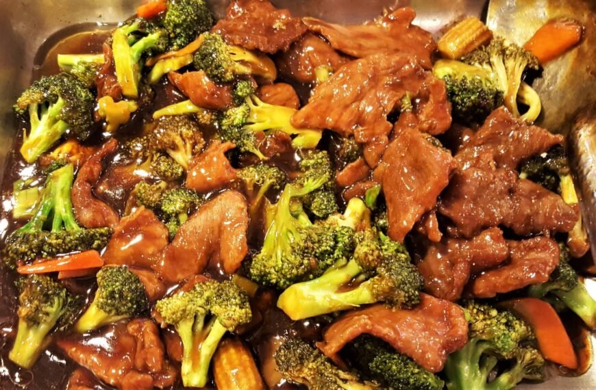 Beef and broccoli in a rich oyster sauce served in a pan.