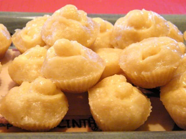 A plate of Brown Sugar Puto, a Filipino steamed rice cake, with a soft and fluffy texture, showcasing a light brown color from the brown sugar.