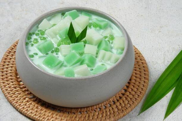 Special Buko Pandan Recipe featuring green pandan jelly and tapioca pearls in a bowl of coconut milk dessert.