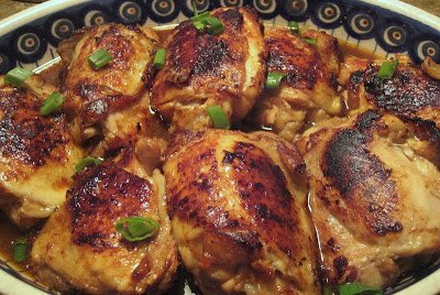 A plate of savory Chicken Adobo garnished with green onions.
