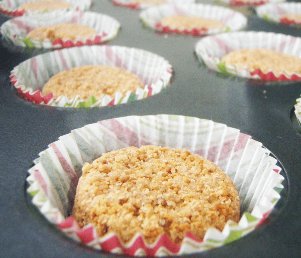 Several pieces of Coated Polvoron placed in colorful paper liners. These crumbly and buttery Filipino shortbread cookies have a golden-brown hue and are arranged neatly in a baking tray, ready to be enjoyed.