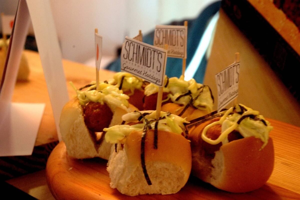 Bite-sized crispy cheesy hotdog sandwiches topped with sauce and seaweed strips