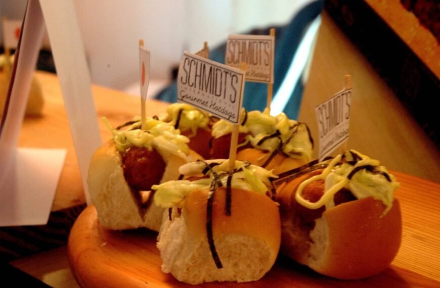 Bite-sized crispy cheesy hotdog sandwiches topped with sauce and seaweed strips