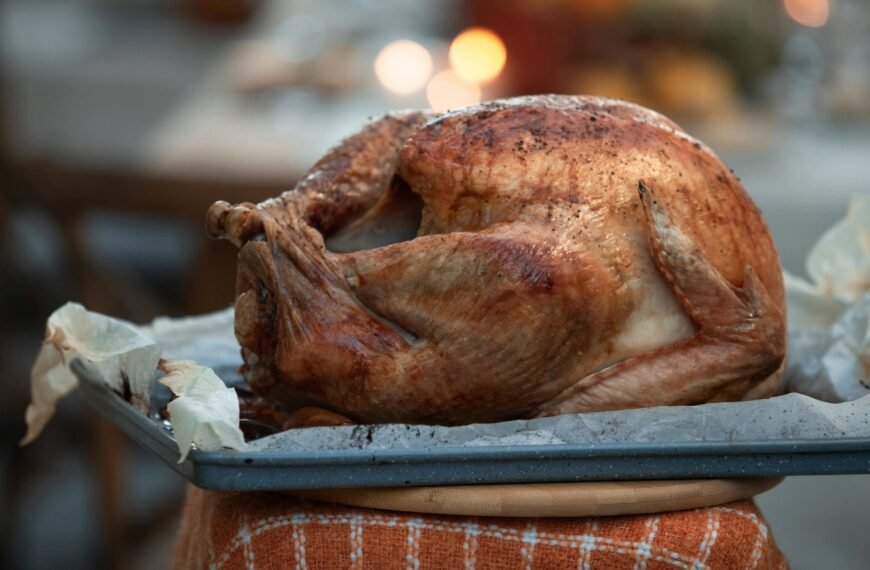 A perfectly roasted chicken resting on a baking tray.