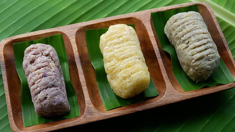 Three variations of Nilupak Na Balinghoy, a traditional Filipino cassava dish, neatly served on banana leaves, representing the classic Nilupak Na Balinghoy Recipe.