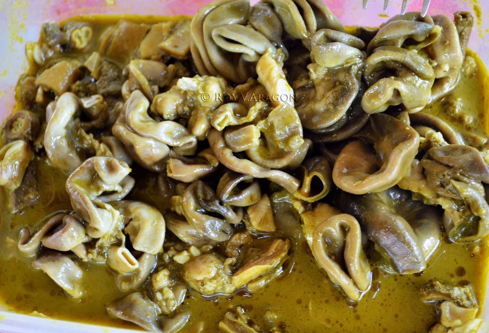A dish of Filipino Papaitan made from beef innards in a savory broth.