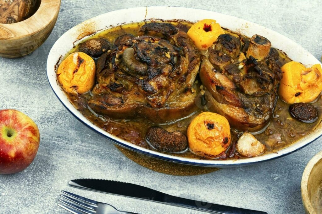 A savory Pata Hamonado dish, featuring slow-cooked pork leg in a sweet pineapple sauce, accompanied by roasted fruits and vegetables, showcasing the rich flavors of this Filipino recipe.