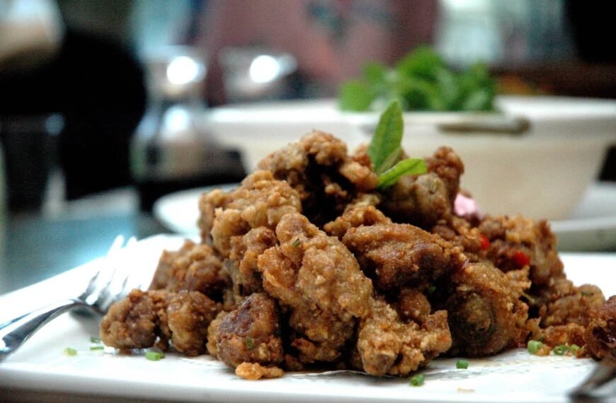 The image shows a delicious serving of Pata Tim, a Filipino dish made from braised pork leg or hock, slow-cooked until tender. The dish is known for its rich, savory flavor, often enhanced with a slightly sweet and aromatic sauce.