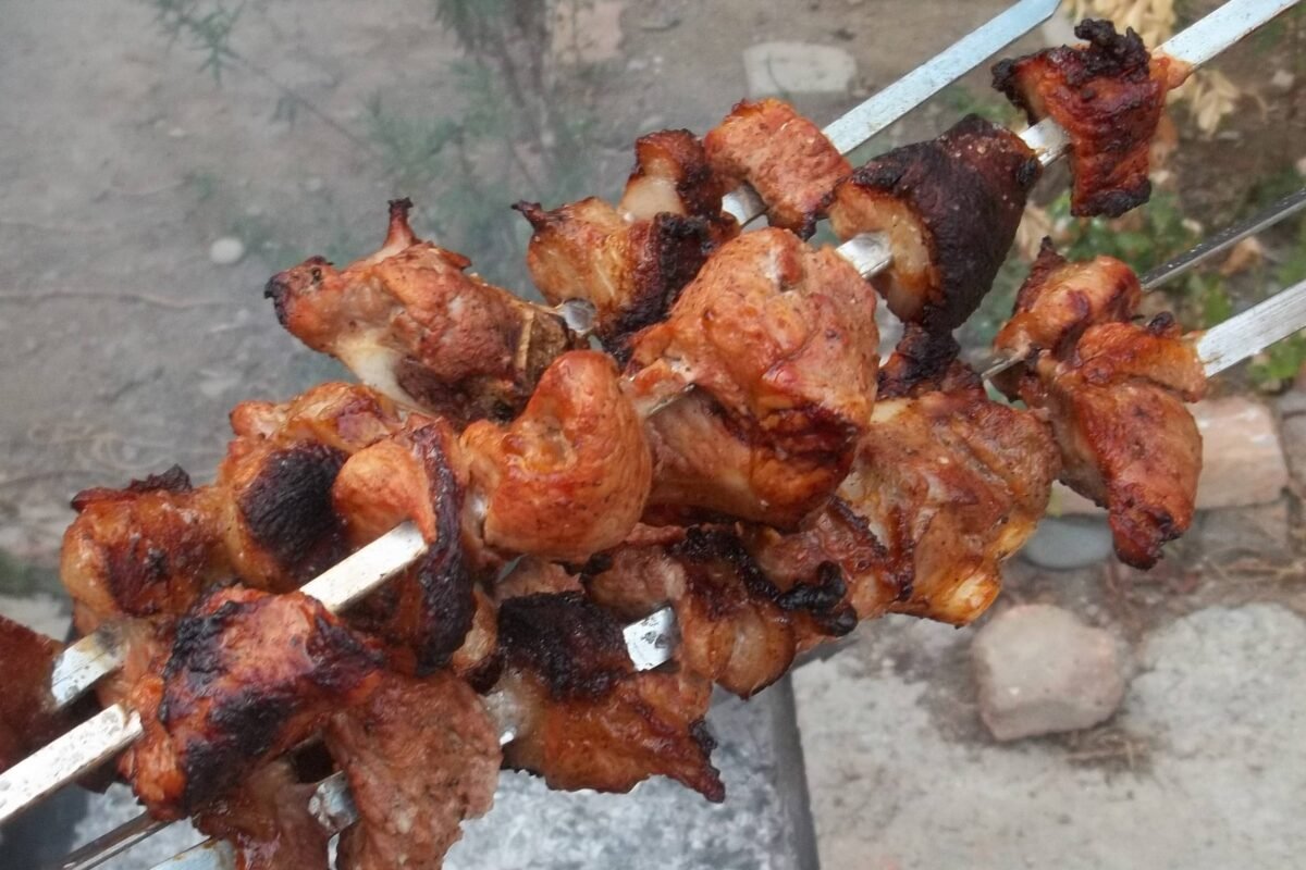 Grilled pork BBQ skewers with a crispy, charred finish.