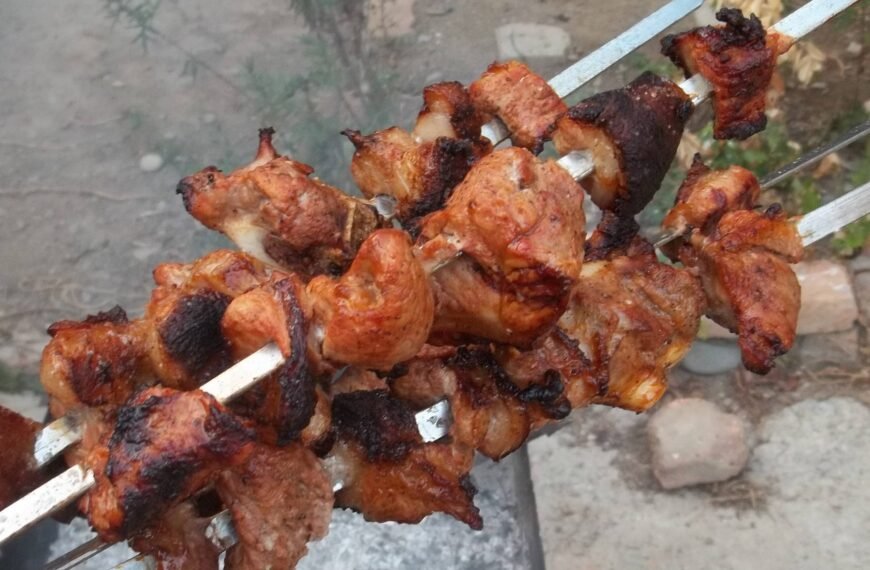 Grilled pork BBQ skewers with a crispy, charred finish.