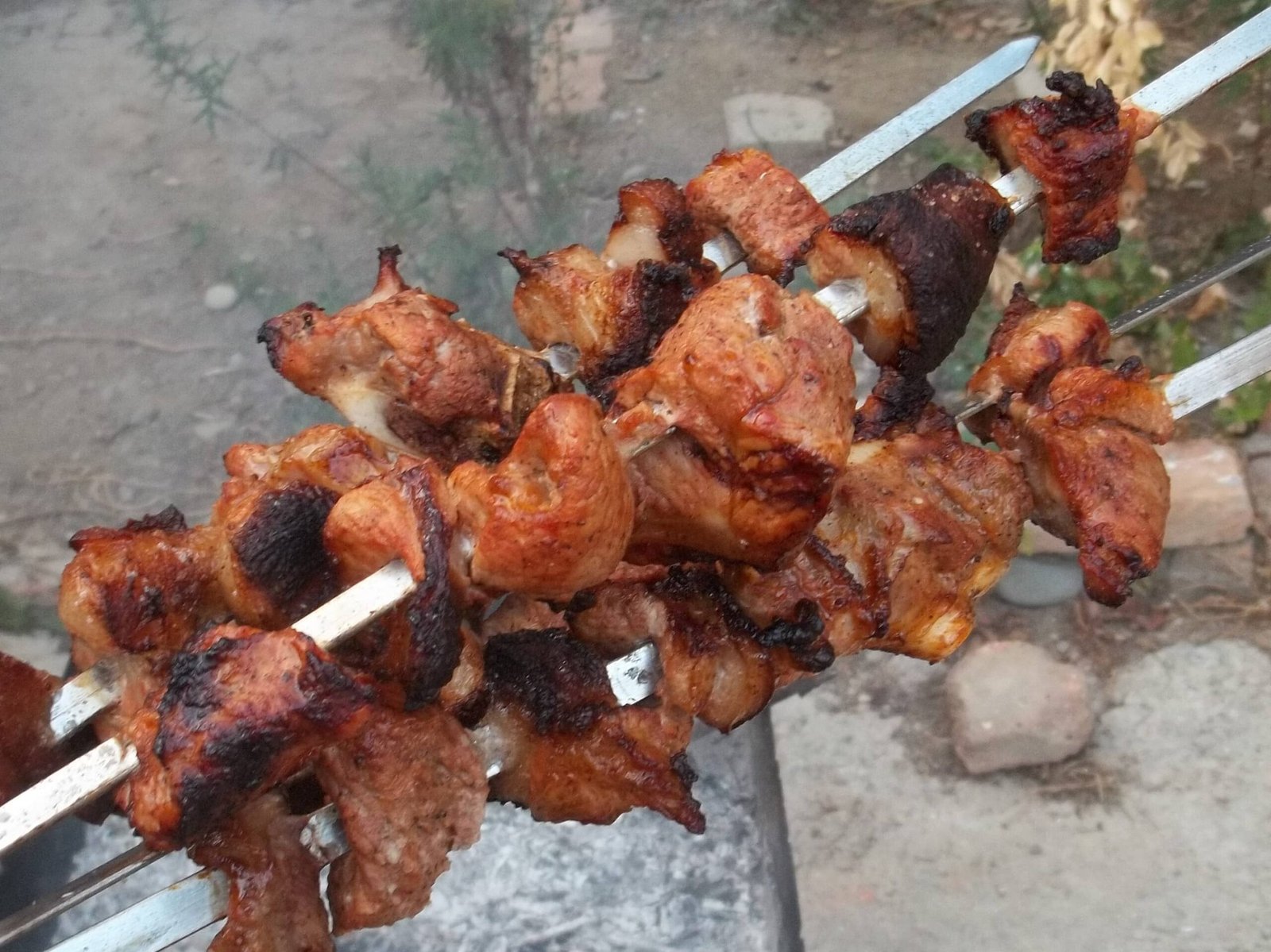 Grilled pork BBQ skewers with a crispy, charred finish.